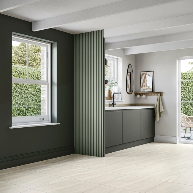 Kitchen dry wall panelled in juniper green to match a colour-drenched scheme
